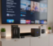A side-by-side comparison of the Firestick 4K Max vs. Fire TV Cube on a modern entertainment stand.